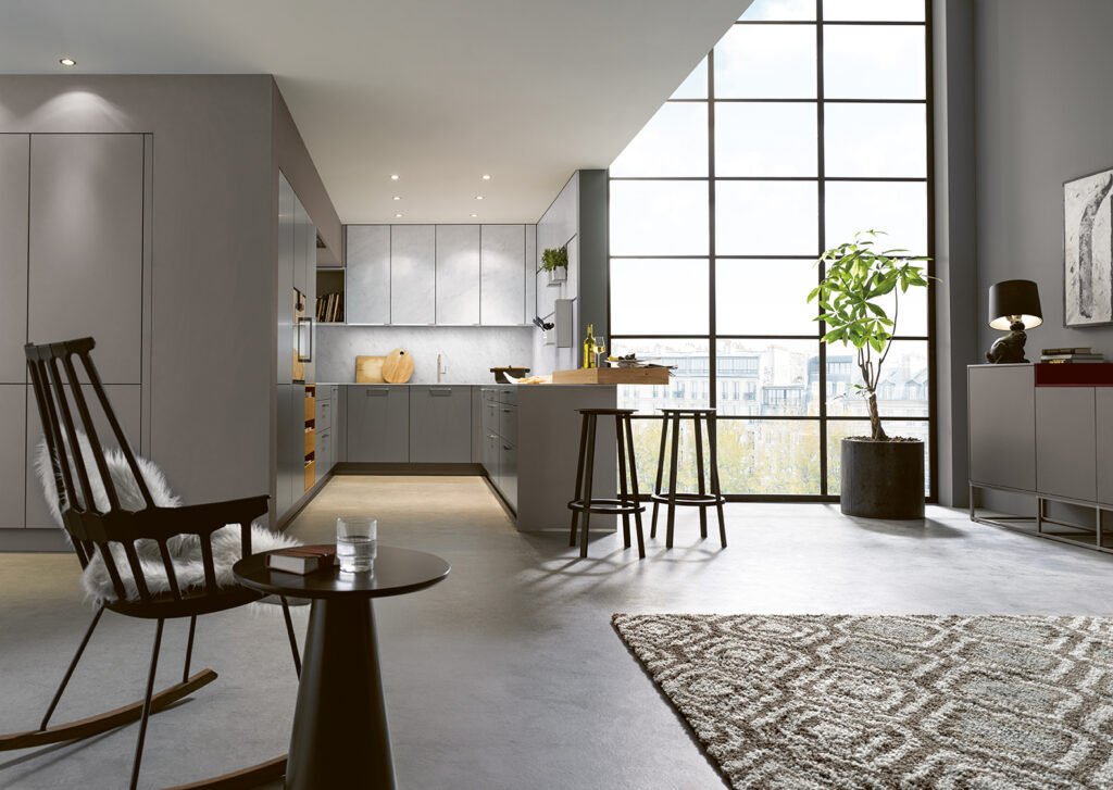 Grey U-shaped kitchen in open plan living room