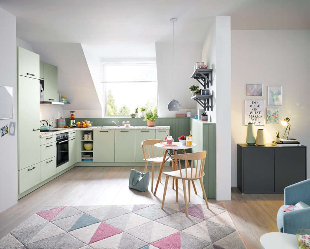 Light green L-shaped kitchen in open plan living room